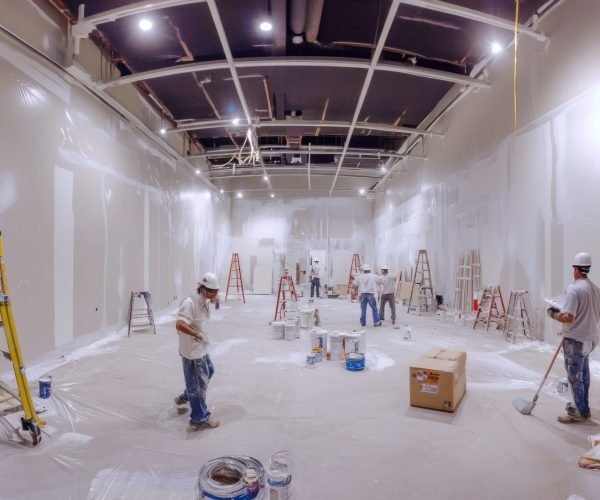 A panoramic image of multiple painters working on the interior of a building, with walls being coated with fresh paint, capturing teamwork and the efficiency of the painting process --ar 16:9 --v 6.1 Job ID: 3e118b7c-8a95-4f40-9761-d63e908a6169